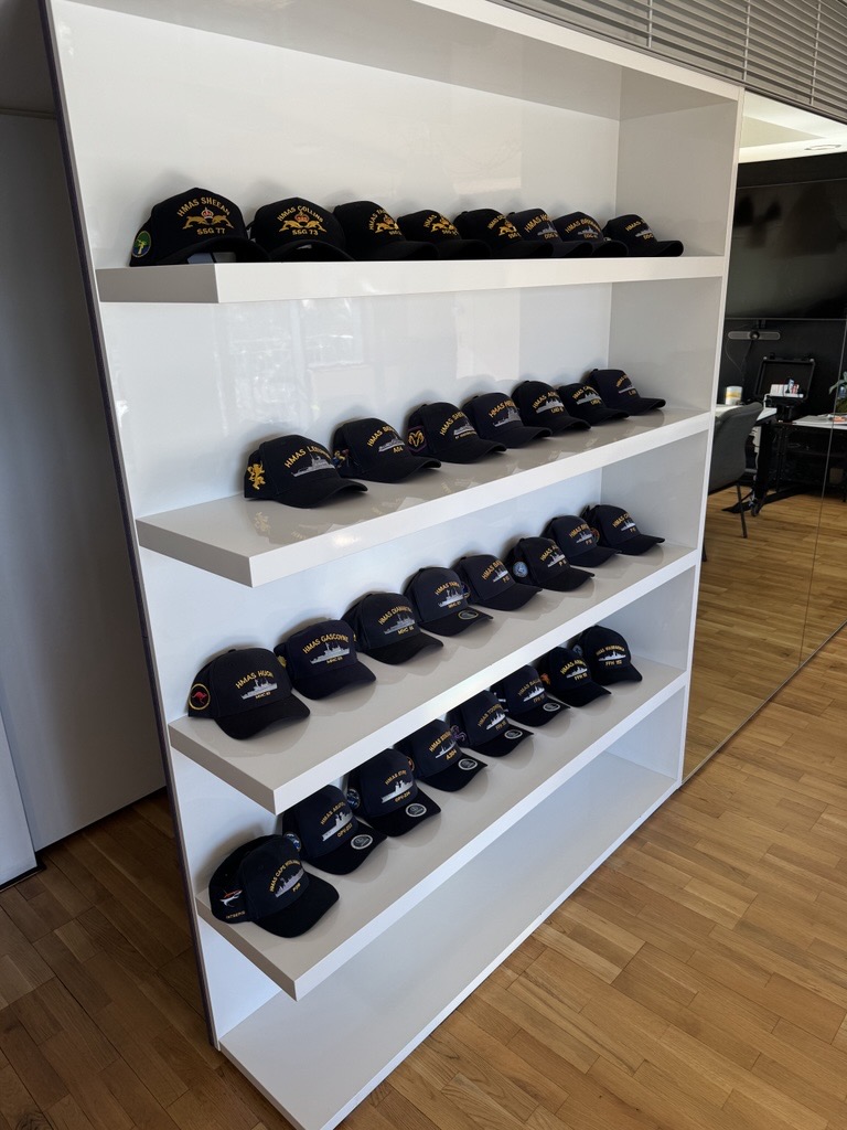 The BlueCats wall of honour — a cap from every vessel deployed with OneTag